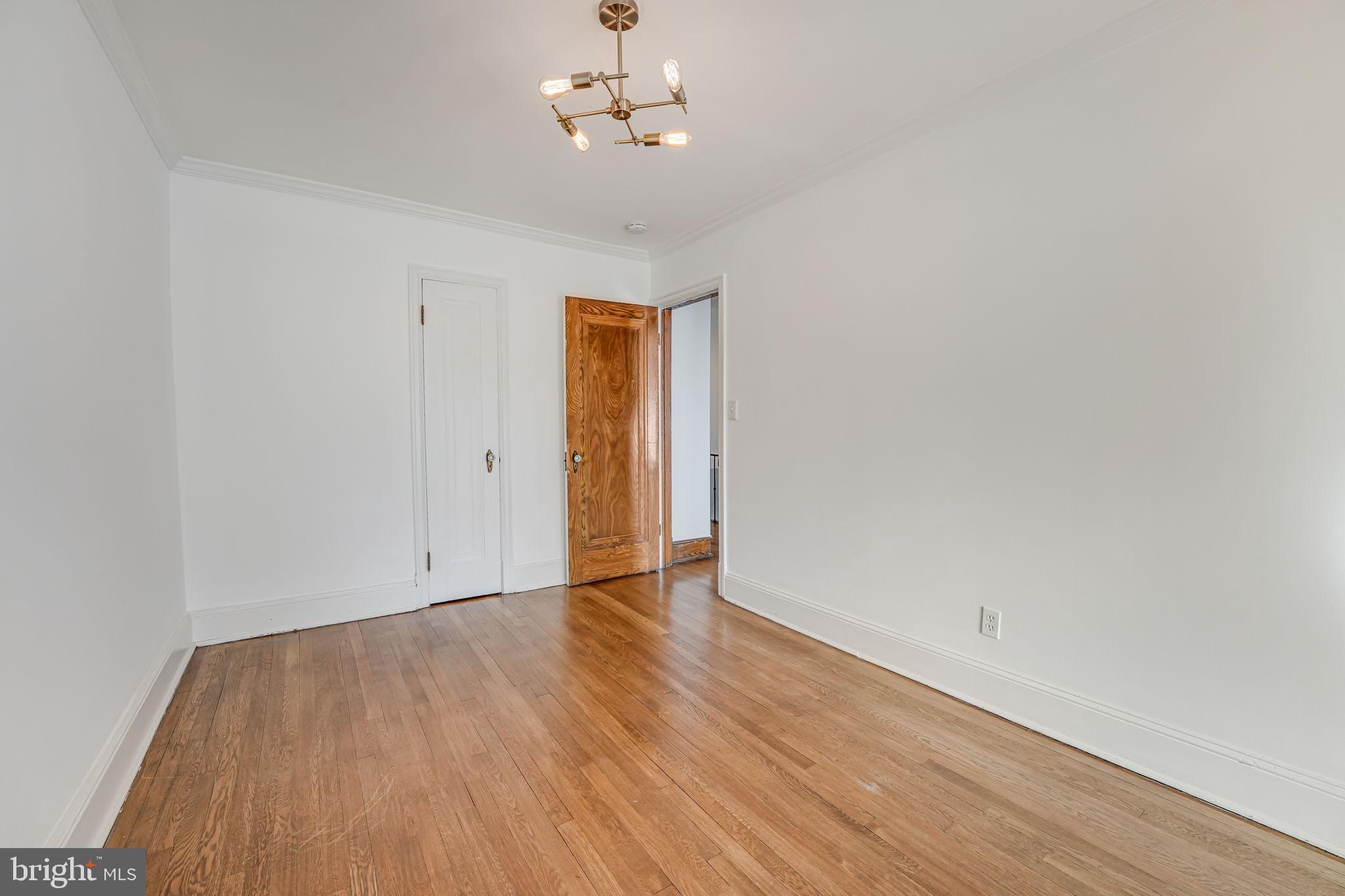 1304 Rittenhouse Street Northwest Washington, DC 20011 - Photo 35 of 50 an empty room with wooden floor and windows