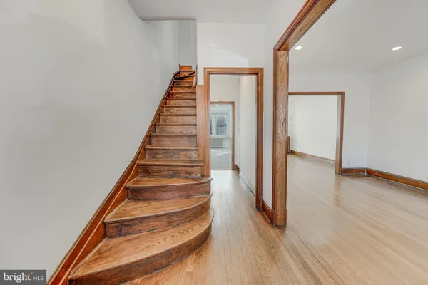 an entryway with wooden floor and cabinet