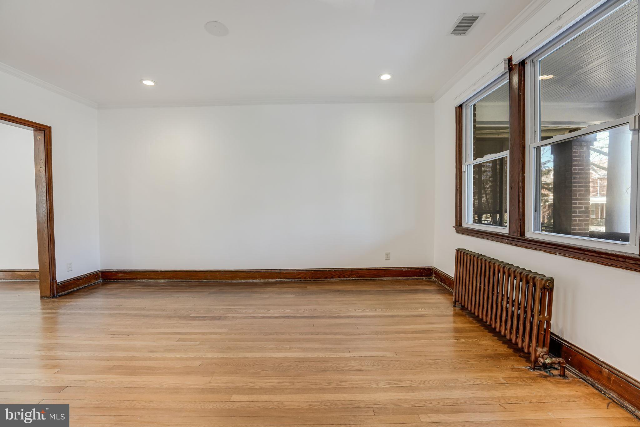 1304 Rittenhouse Street Northwest Washington, DC 20011 - Photo 7 of 50 a view of an empty room with wooden floor and a window