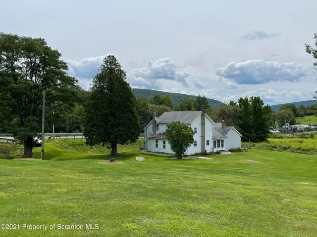 a living room with furniture and a lamp