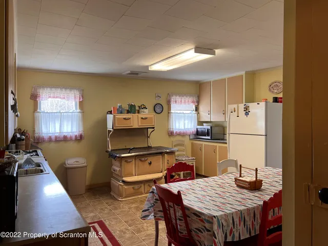 a living room with furniture a window and a flat screen tv