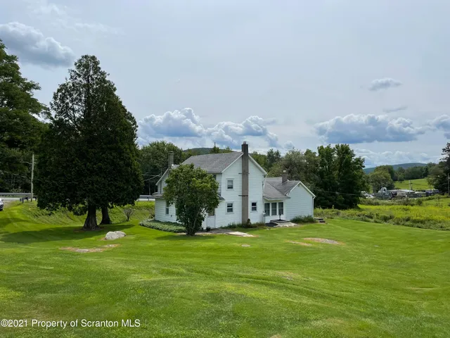a living room with furniture a lamp and a window
