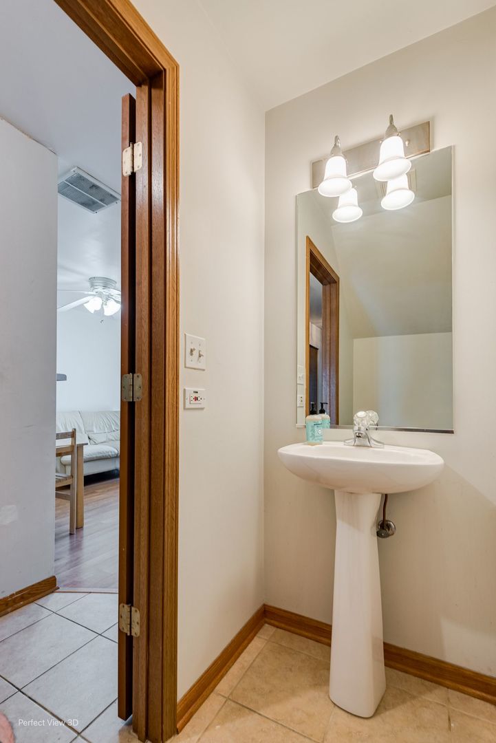 1793 Grove Avenue Schaumburg, IL 60193 - Photo 15 of 16 a bathroom with a sink and a mirror