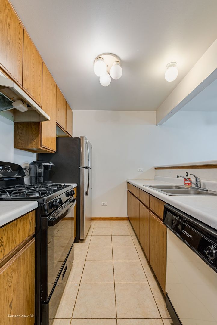 1793 Grove Avenue Schaumburg, IL 60193 - Photo 3 of 16 a kitchen with stainless steel appliances a stove refrigerator sink and microwave