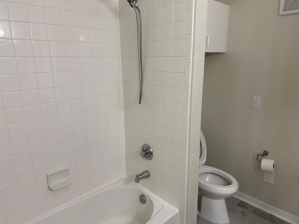 3757 Conroy Road, Unit 2512 Orlando, FL 32839 - Photo 11 of 13 a bathroom with a toilet and a shower
