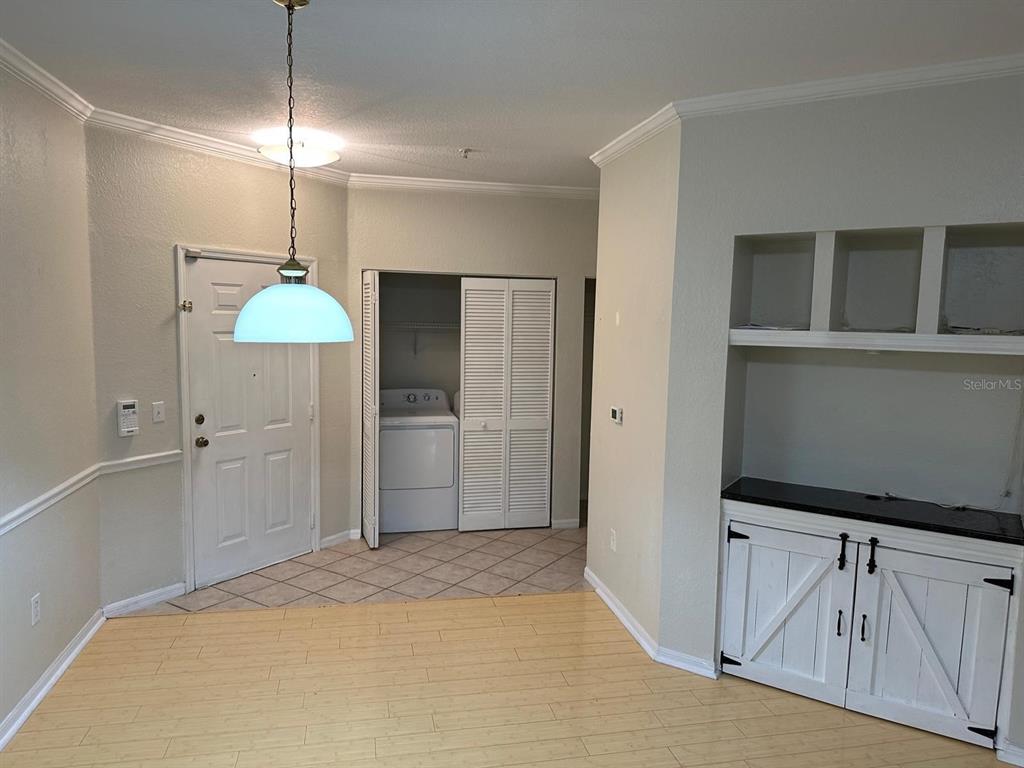 3757 Conroy Road, Unit 2512 Orlando, FL 32839 - Photo 4 of 13 a view of a kitchen with a fridge and a ceiling fan