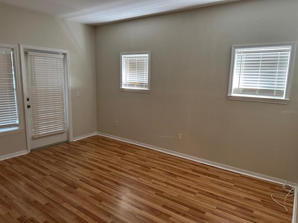 3757 Conroy Road, Unit 2512 Orlando, FL 32839 - Photo 6 of 13 a view of empty room with wooden floor and fan