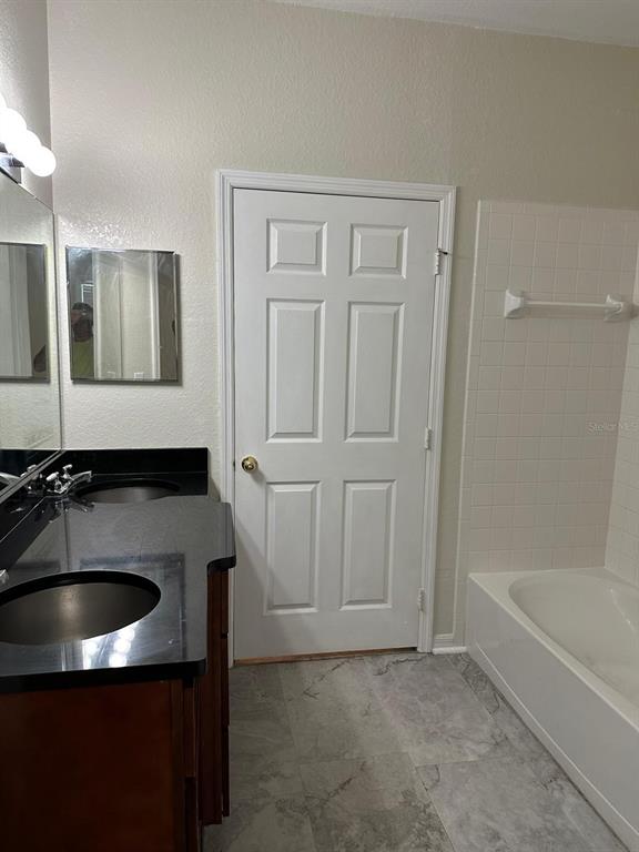 3757 Conroy Road, Unit 2512 Orlando, FL 32839 - Photo 9 of 13 a bathroom with a sink and a bathtub