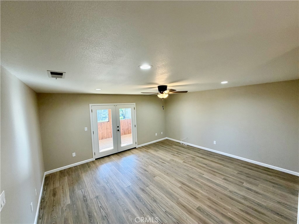 648 Flora Drive Oceanside, CA 92057 - Photo 4 of 31 an empty room with wooden floor and windows