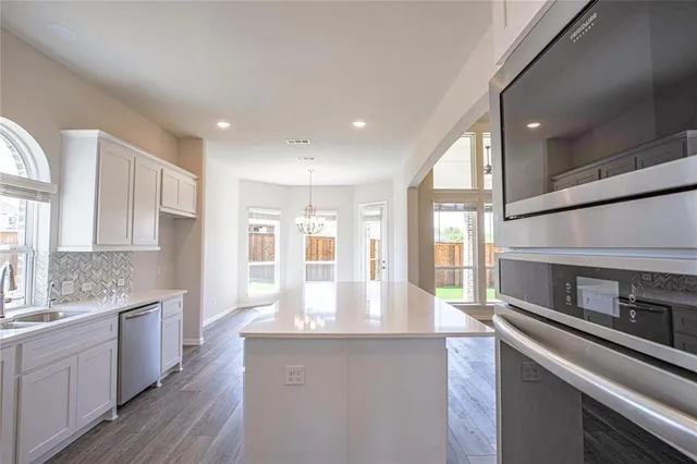 a kitchen with stainless steel appliances granite countertop a sink and cabinets