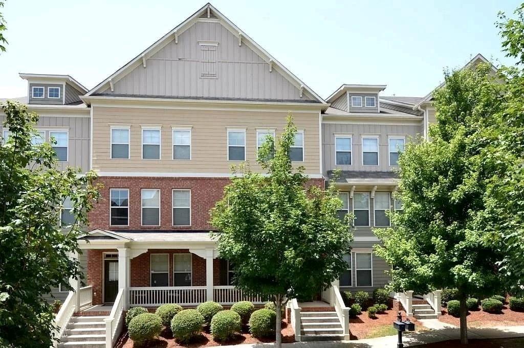 a front view of a residential apartment building with a yard