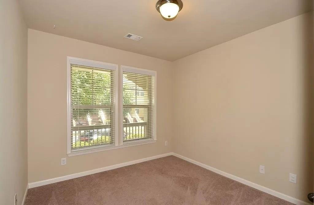 4411 Village Field Place Suwanee, GA 30024 - Photo 5 of 9 an empty room with windows
