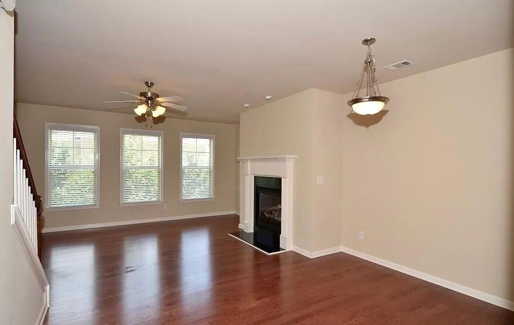 4411 Village Field Place Suwanee, GA 30024 - Photo 7 of 9 wooden floor in an empty room with a window
