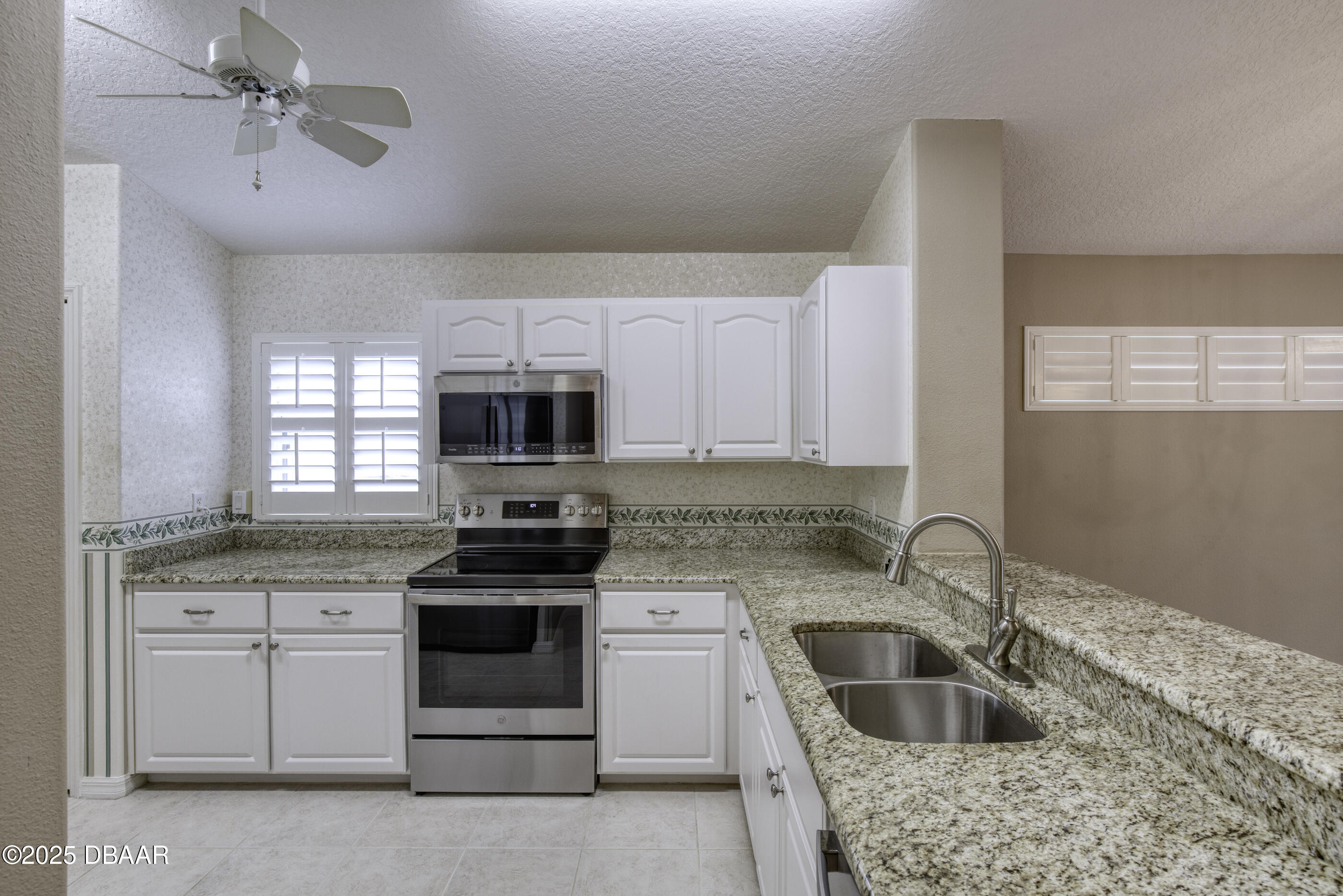 38 Lake Walden Trail Ormond Beach, FL 32174 - Photo 12 of 72 a kitchen with granite countertop a sink stainless steel appliances and cabinets
