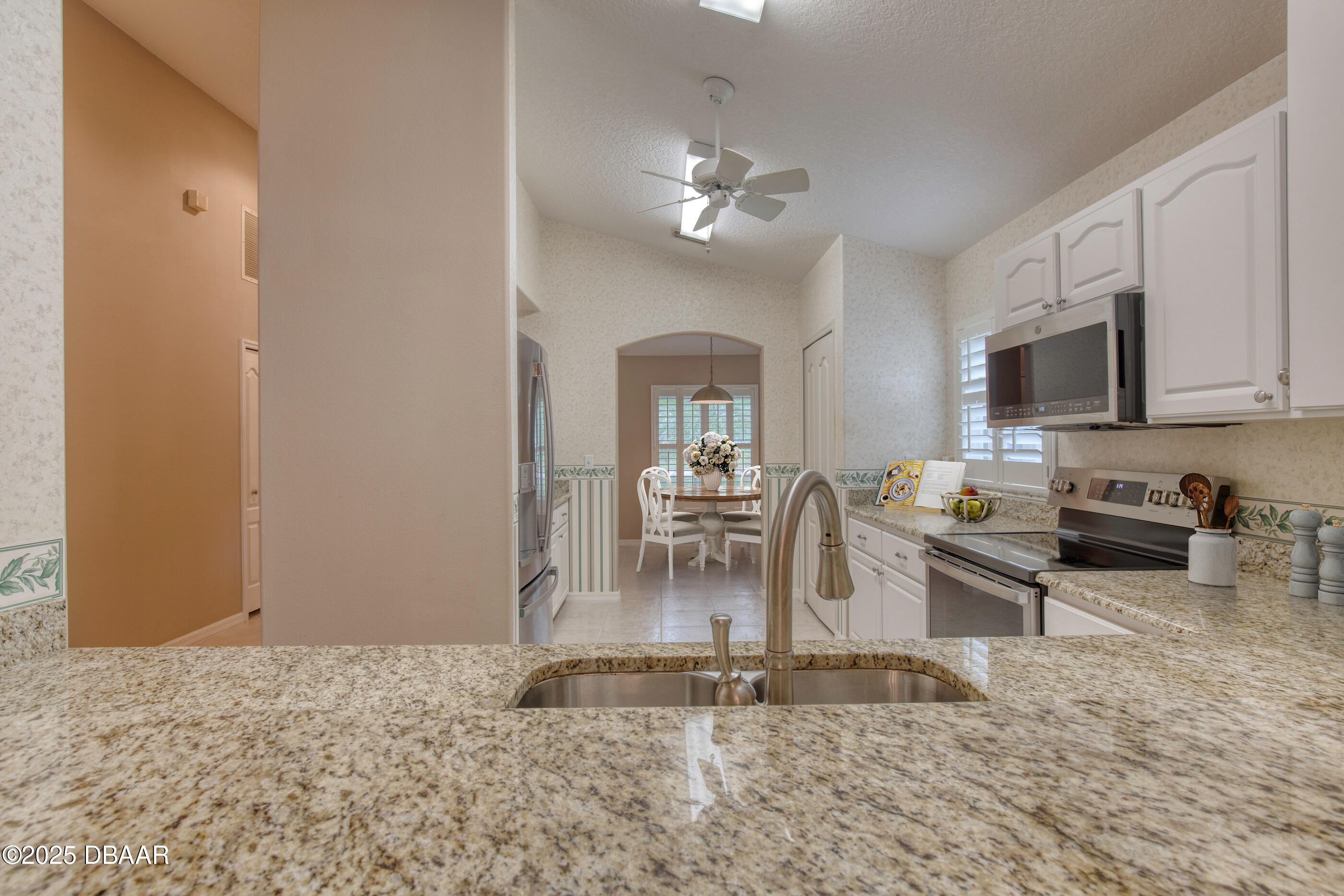 38 Lake Walden Trail Ormond Beach, FL 32174 - Photo 15 of 72 a view of a kitchen with dining area a sink a refrigerator and window