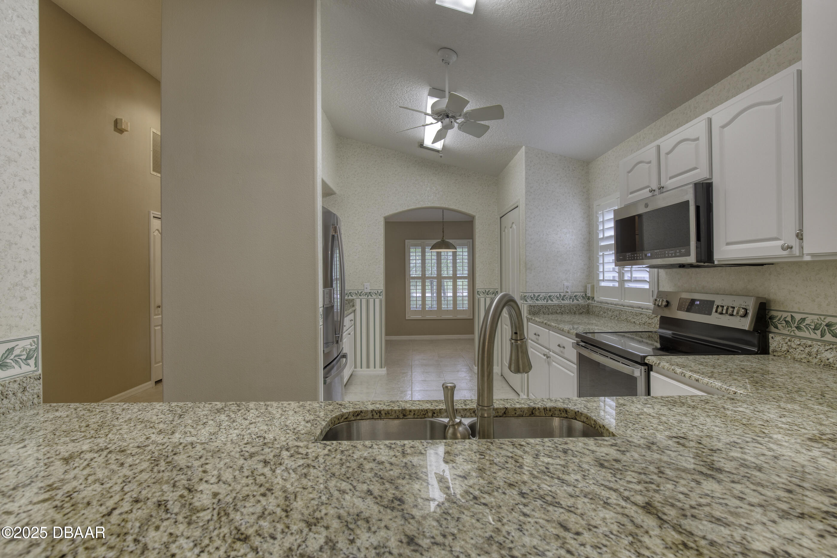 38 Lake Walden Trail Ormond Beach, FL 32174 - Photo 16 of 72 a kitchen with stainless steel appliances granite countertop a sink and a granite counter top
