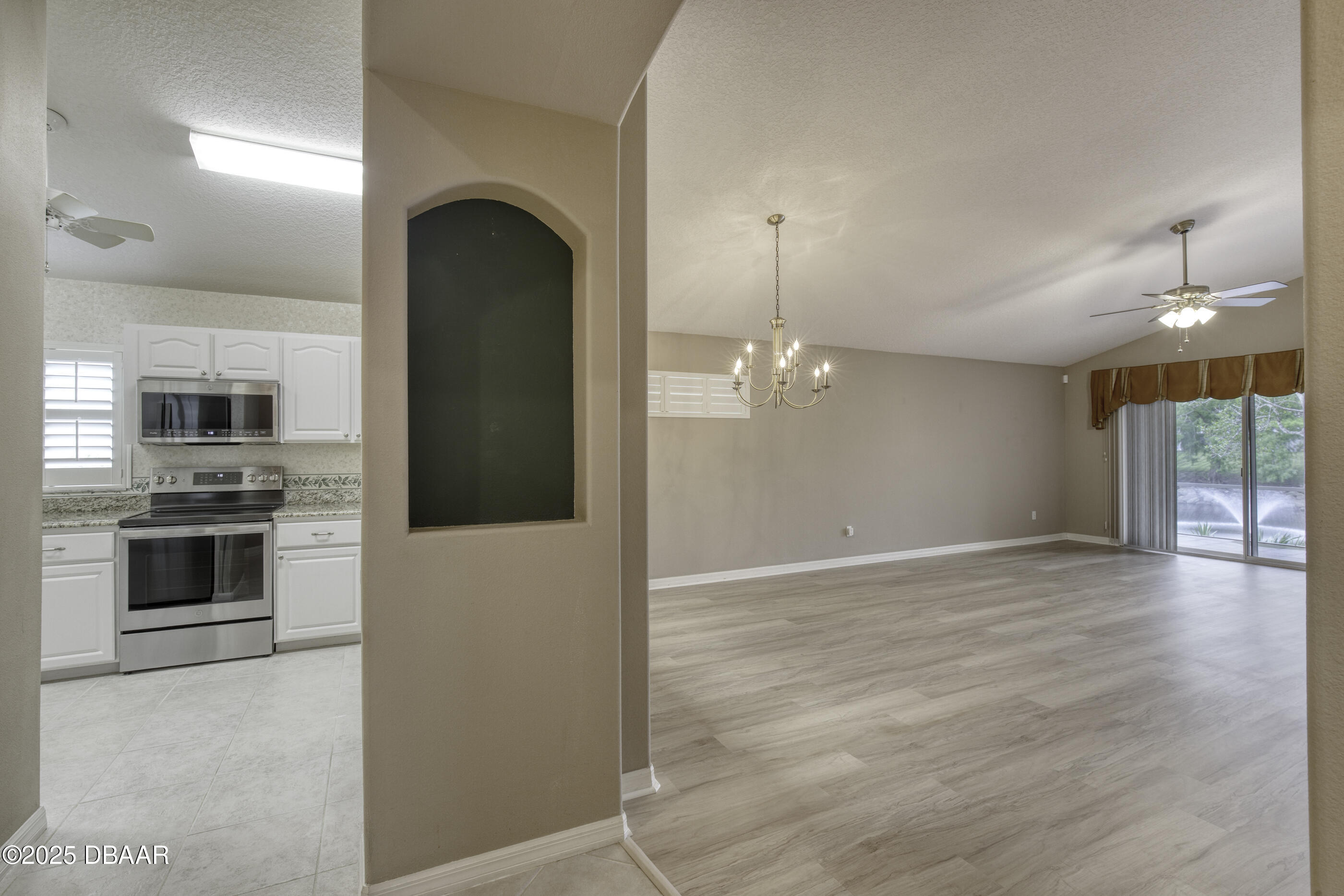 38 Lake Walden Trail Ormond Beach, FL 32174 - Photo 18 of 72 a view of a kitchen with a stove cabinets and a wooden floor