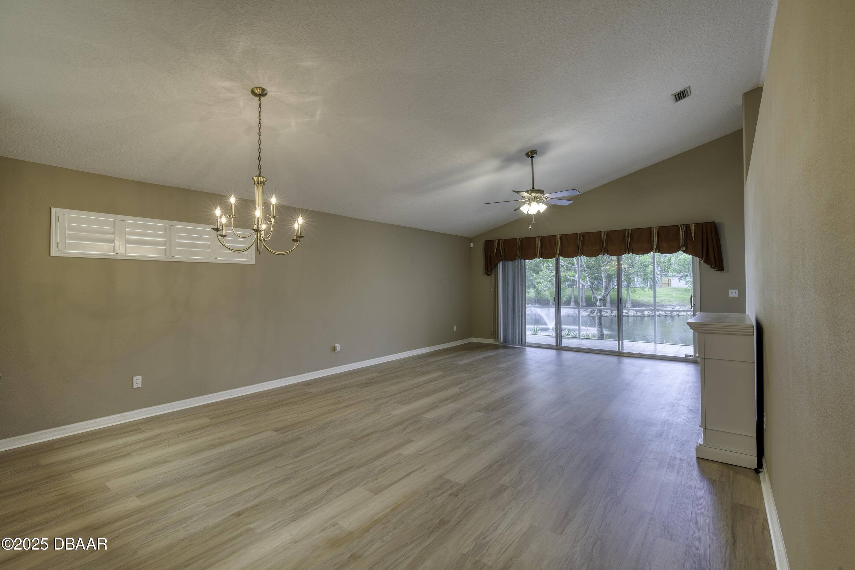 38 Lake Walden Trail Ormond Beach, FL 32174 - Photo 20 of 72 a view of empty room with wooden floor and fan