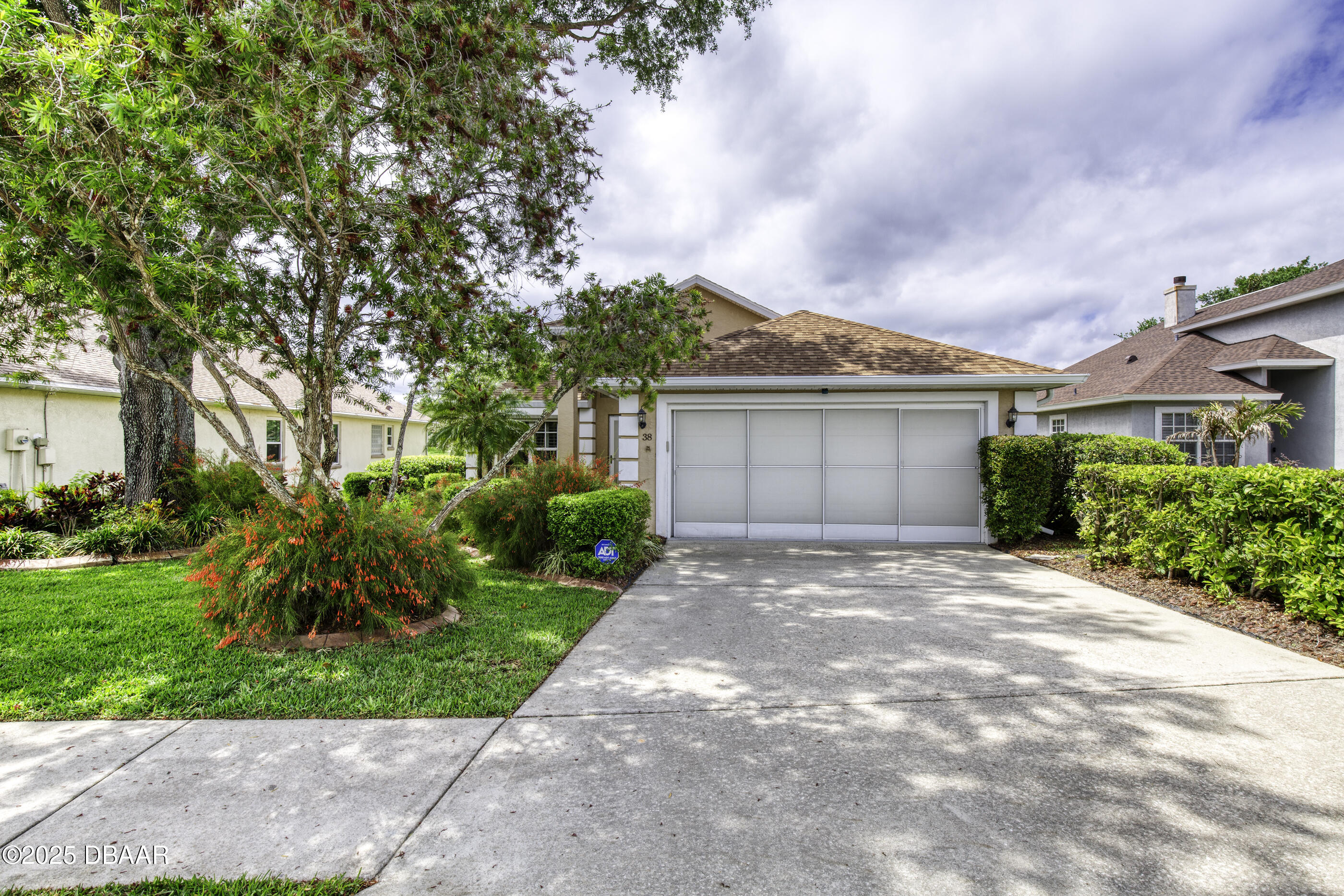 38 Lake Walden Trail Ormond Beach, FL 32174 - Photo 2 of 72 a front view of a house with a garden