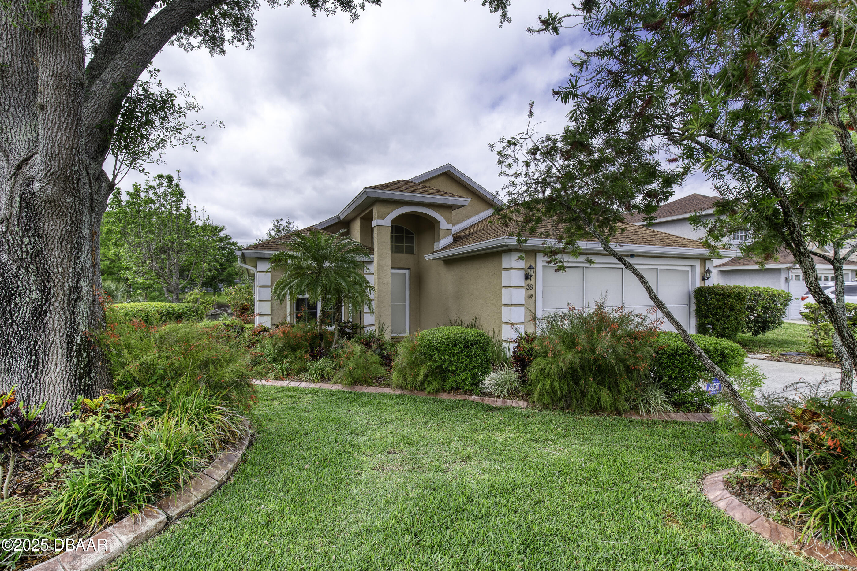 38 Lake Walden Trail Ormond Beach, FL 32174 - Photo 3 of 72 a front view of a house with garden