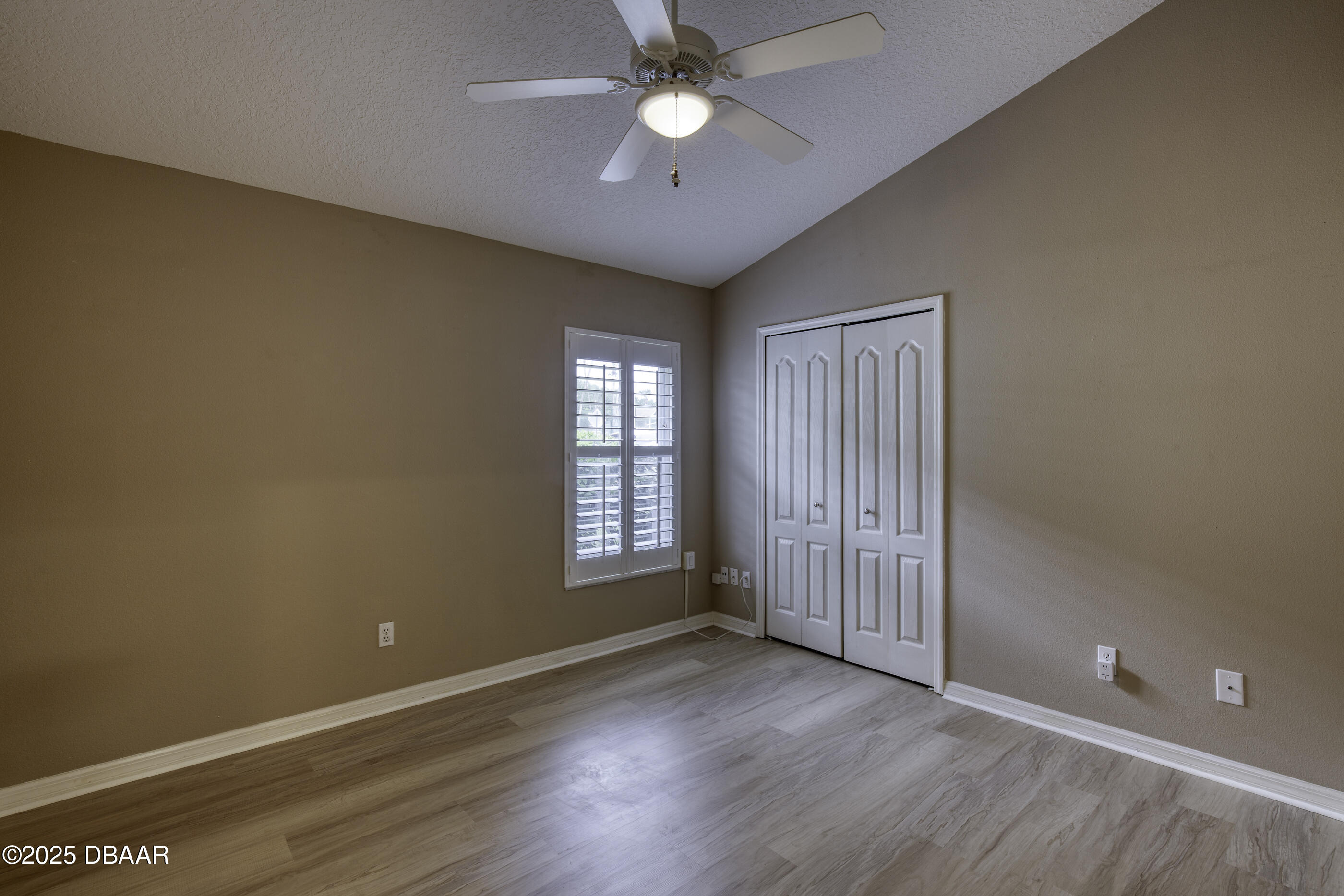 38 Lake Walden Trail Ormond Beach, FL 32174 - Photo 31 of 72 an empty room with wooden floor and a ceiling fan