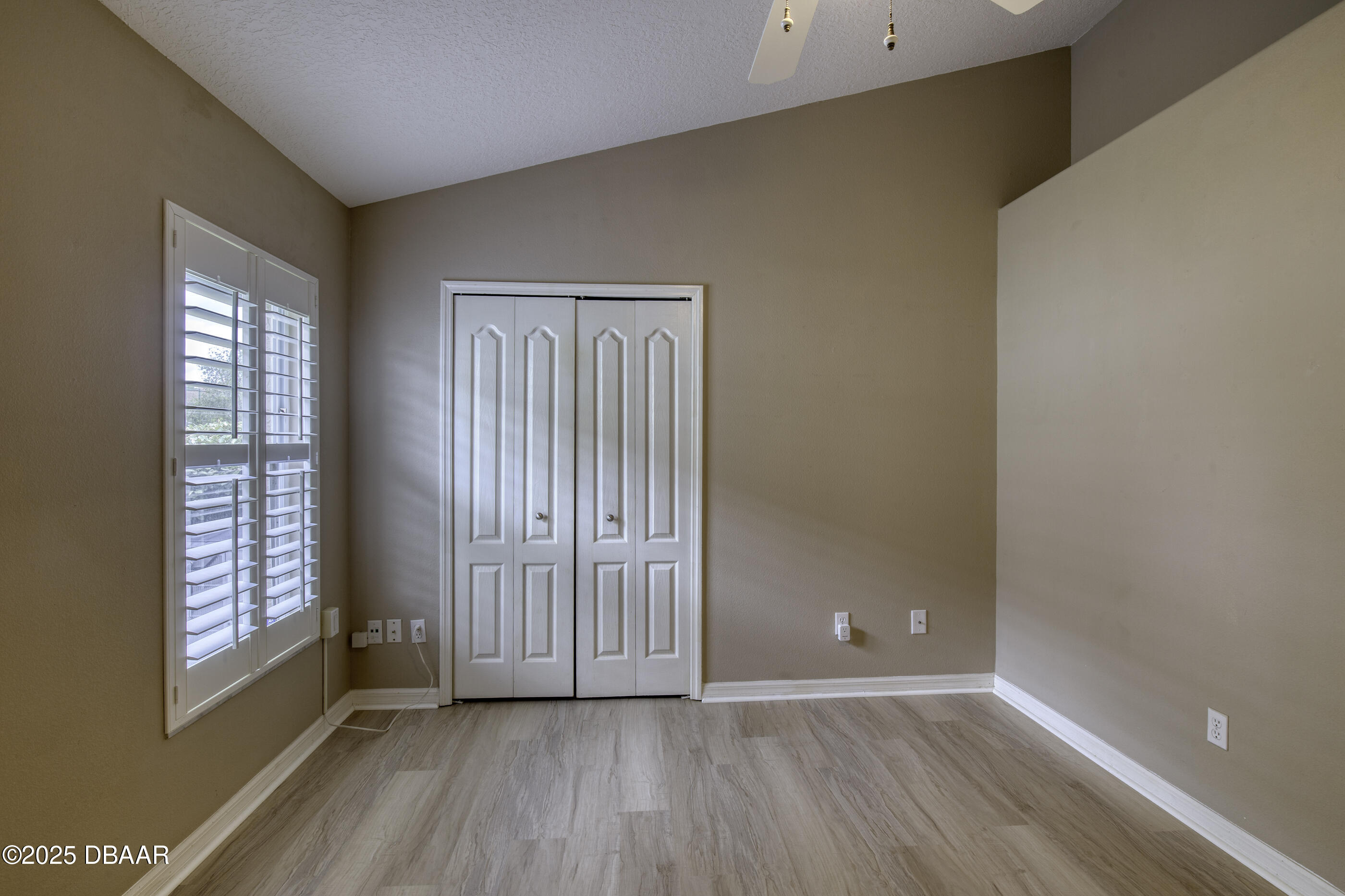 38 Lake Walden Trail Ormond Beach, FL 32174 - Photo 33 of 72 a view of an empty room with wooden floor and a window