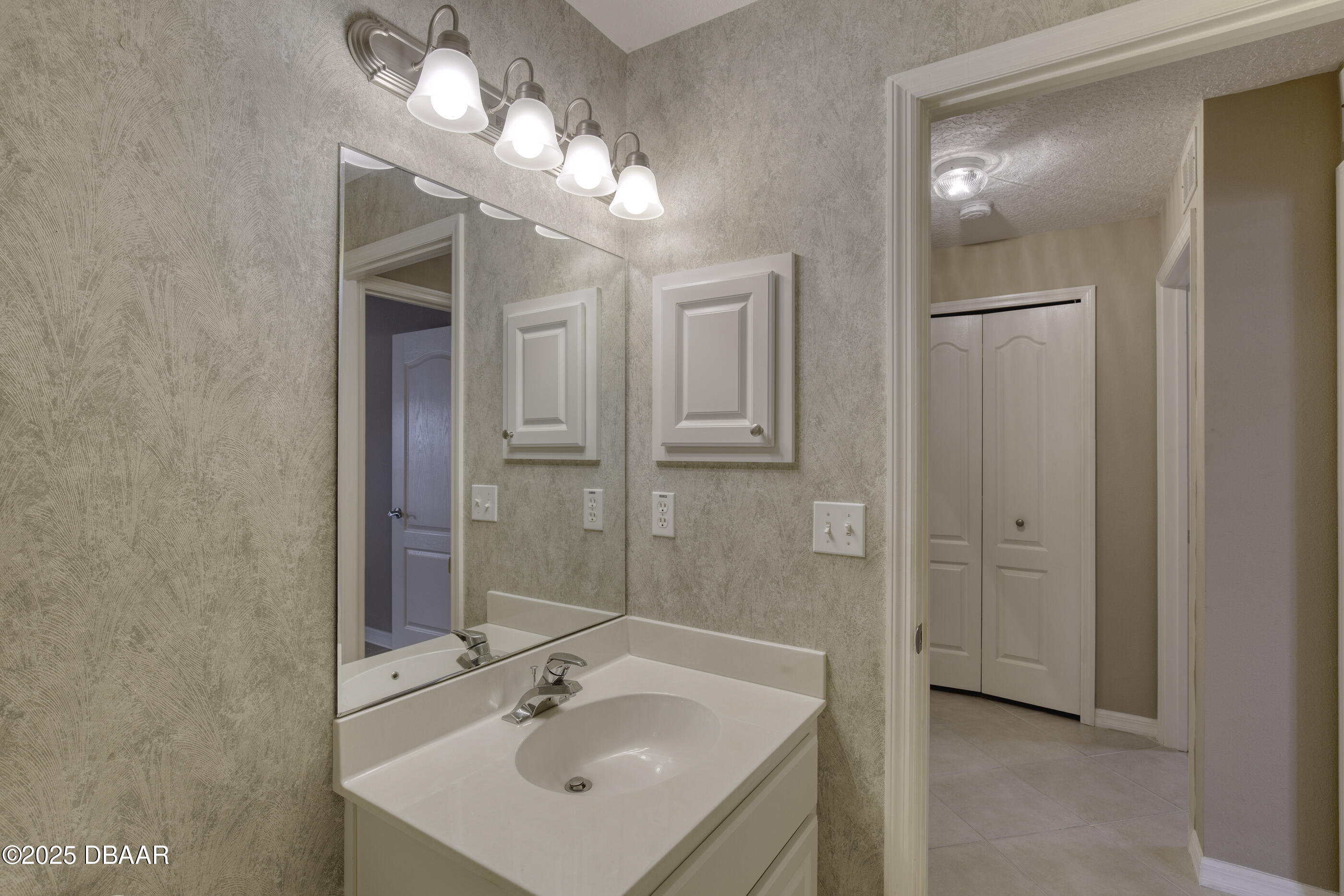 38 Lake Walden Trail Ormond Beach, FL 32174 - Photo 35 of 72 a bathroom with a sink a light fixture and a mirror
