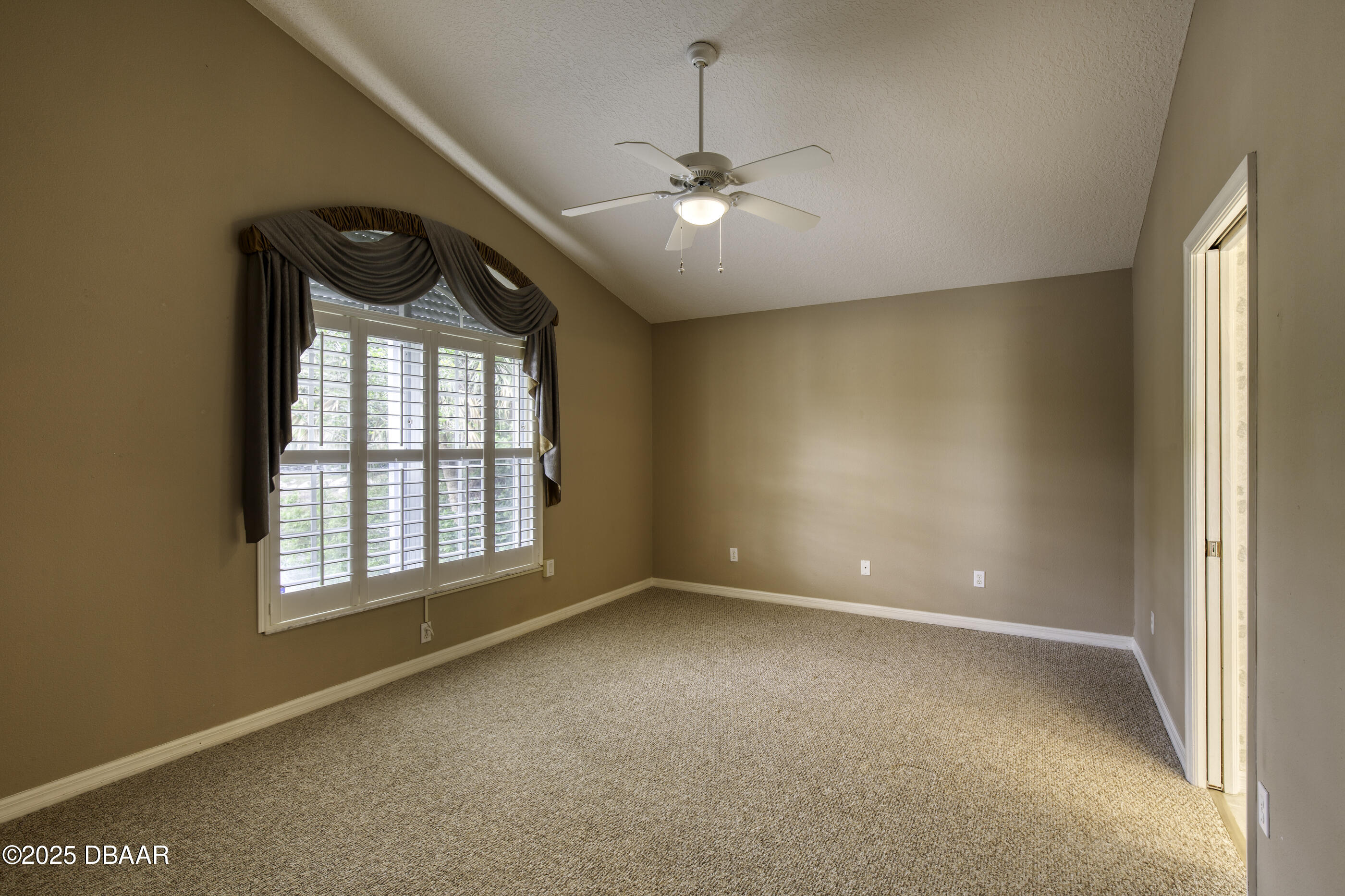 38 Lake Walden Trail Ormond Beach, FL 32174 - Photo 37 of 72 an empty room with windows and chandelier fan