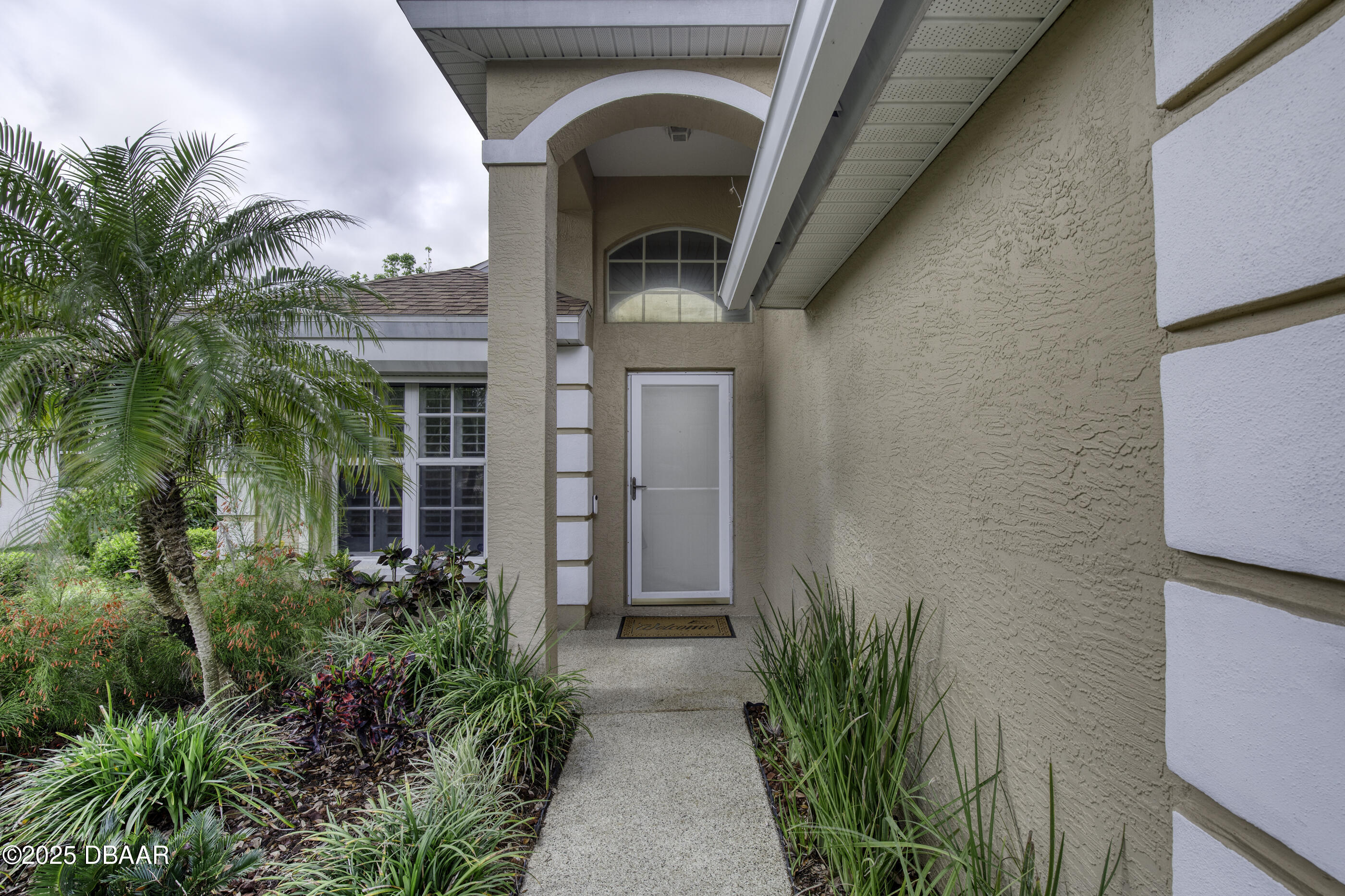 38 Lake Walden Trail Ormond Beach, FL 32174 - Photo 5 of 72 a front view of a house with garden