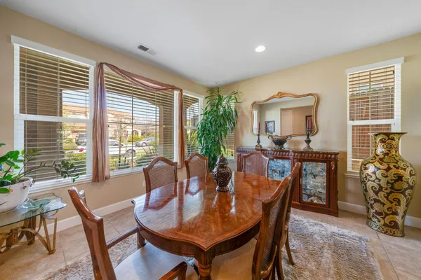 a dining room with furniture window and wooden floor