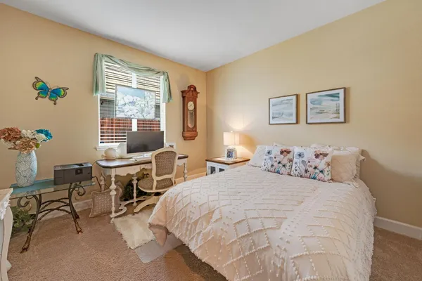 a bedroom with a bed and a table