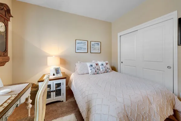 a bedroom with a bed and a desk