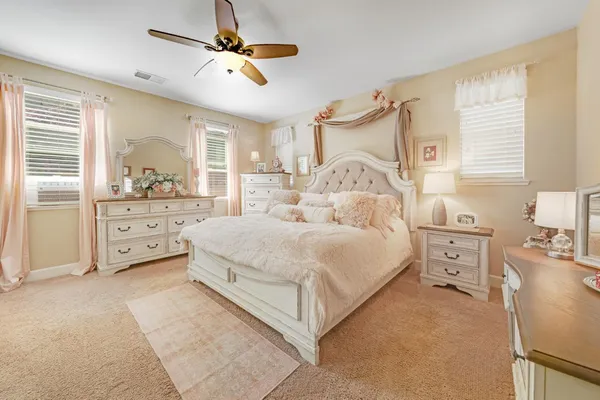 a bedroom with a bed and a chandelier