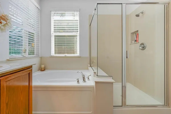 a bathroom with a bathtub and a shower