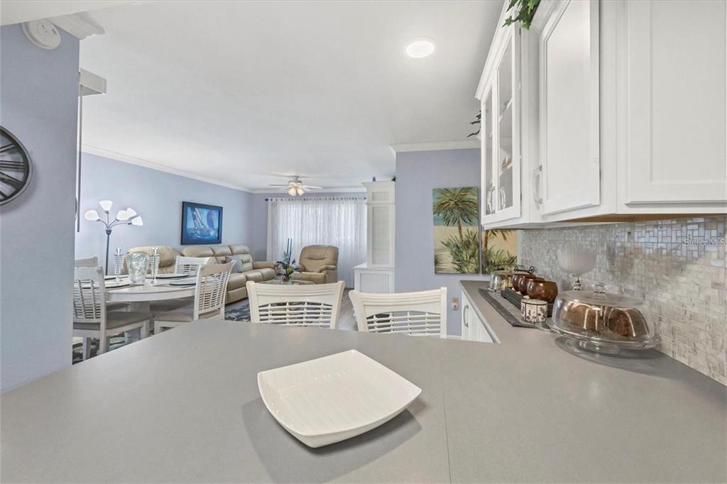 460 Base Avenue East, Unit 113 Venice, FL 34285 - Photo 15 of 25 a kitchen with stainless steel appliances a stove and white cabinets