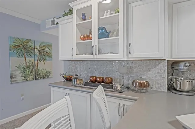 a kitchen with stainless steel appliances a white cabinets and a stove top oven