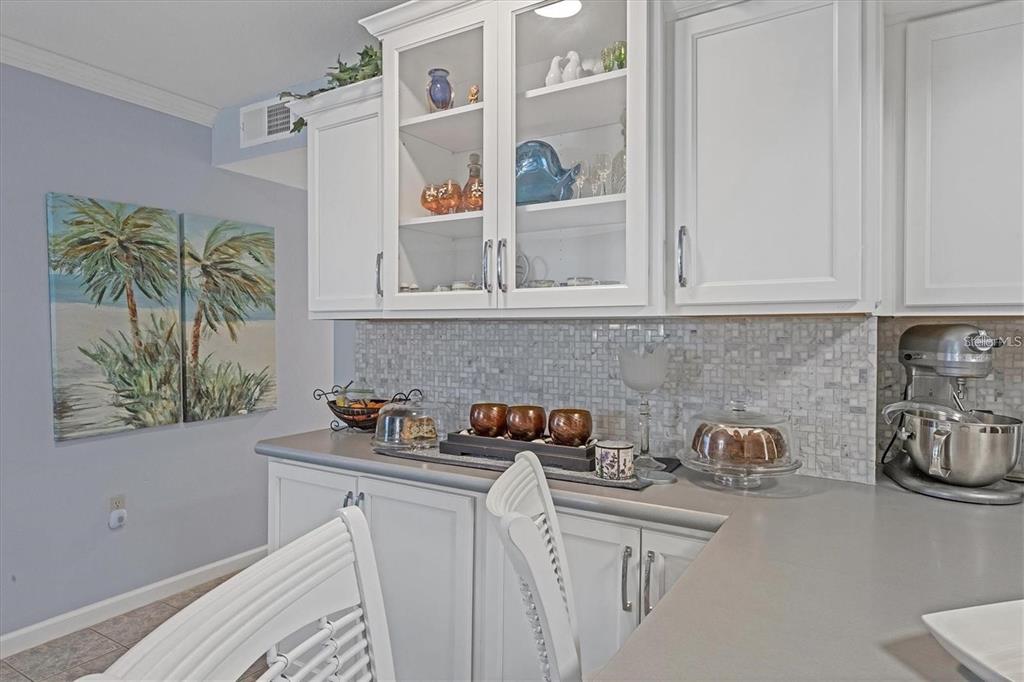 460 Base Avenue East, Unit 113 Venice, FL 34285 - Photo 19 of 25 a kitchen with stainless steel appliances a white cabinets and a stove top oven