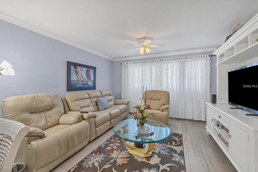 460 Base Avenue East, Unit 113 Venice, FL 34285 - Photo 24 of 25 a living room with furniture and a flat screen tv