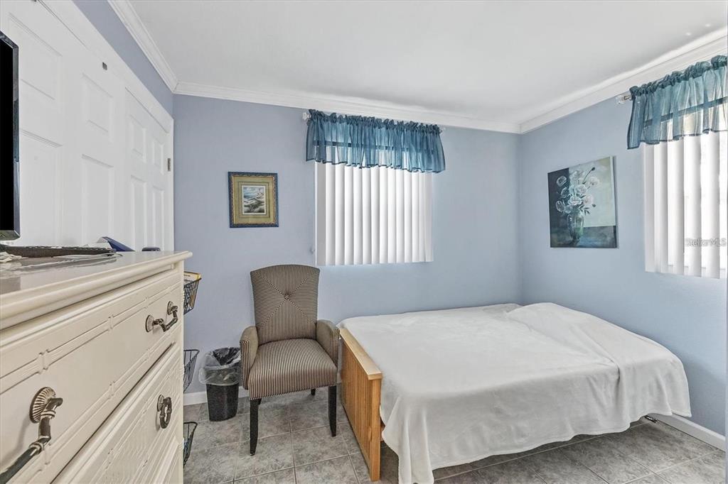 460 Base Avenue East, Unit 113 Venice, FL 34285 - Photo 5 of 25 a bedroom with a bed chair and window