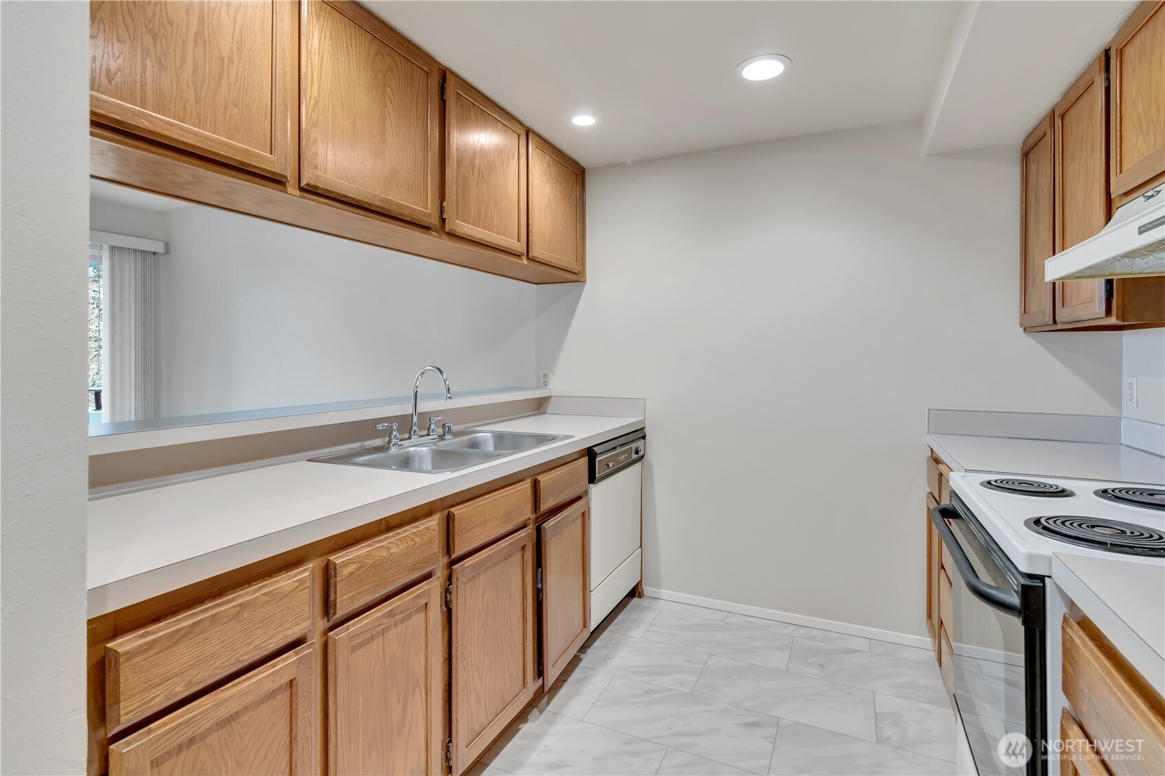 7339 Old Redmond Road, Unit 118 Redmond, WA 98052 - Photo 8 of 25 a kitchen with stainless steel appliances granite countertop a sink and a stove