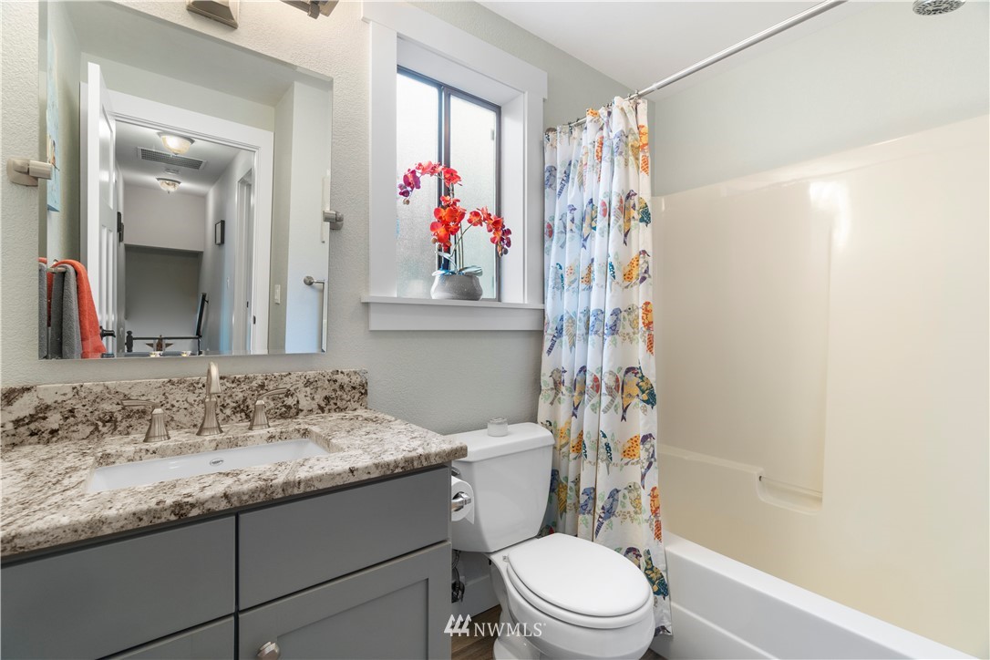 16638 Littlerock Road Southwest Rochester, WA 98579 - Photo 22 of 39 a bathroom with a granite countertop sink a toilet and shower