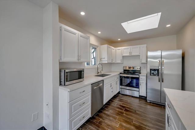 262 Beachview Avenue, Unit 5 Pacifica, CA 94044 - Photo 13 of 23 a kitchen with stainless steel appliances a refrigerator sink and stove