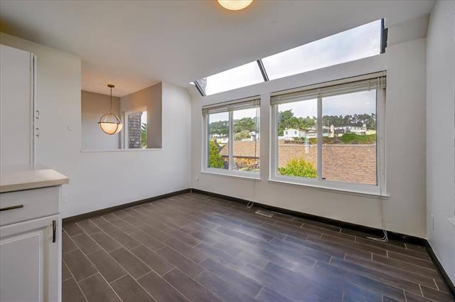 262 Beachview Avenue, Unit 5 Pacifica, CA 94044 - Photo 14 of 23 an empty room with wooden floor and windows