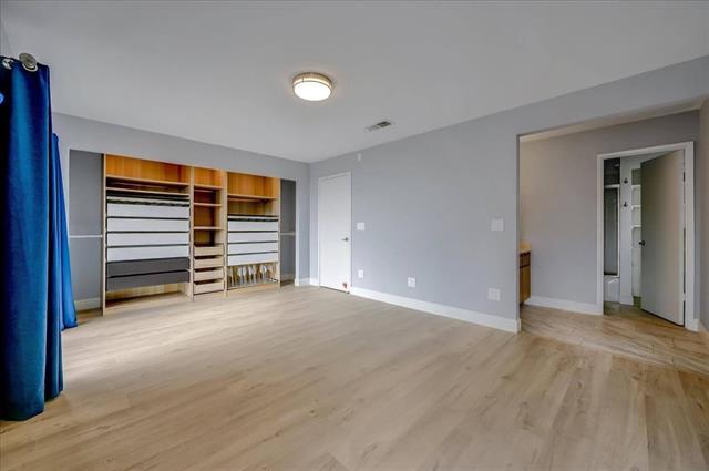 262 Beachview Avenue, Unit 5 Pacifica, CA 94044 - Photo 17 of 23 a view of empty room with wooden floor and fan