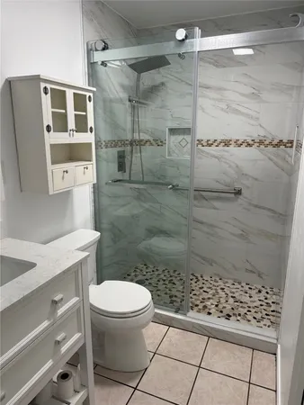 a bathroom with a toilet and a shower