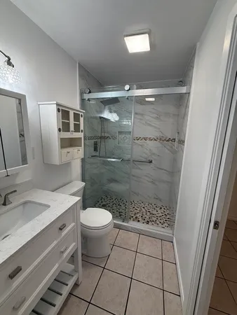 a bathroom with a sink toilet and shower
