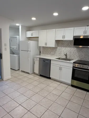a kitchen with a sink a stove and refrigerator