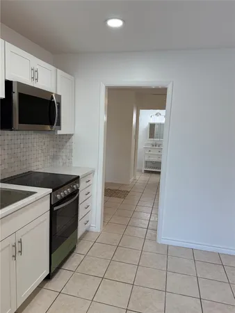 a kitchen with stainless steel appliances granite countertop a sink and a stove