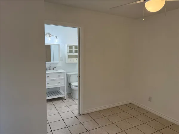 a bathroom with a sink toilet and mirror