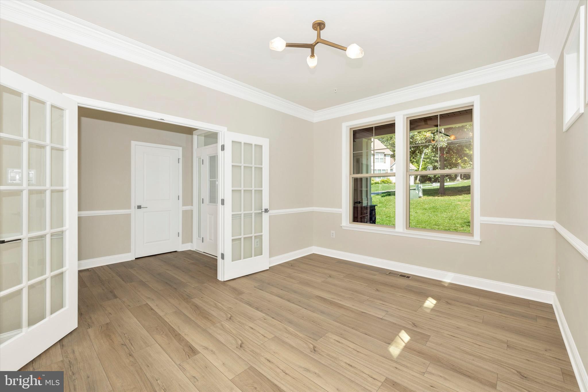 391 Masters Road New Market, MD 21774 - Photo 13 of 71 a view of an empty room with wooden floor and a window